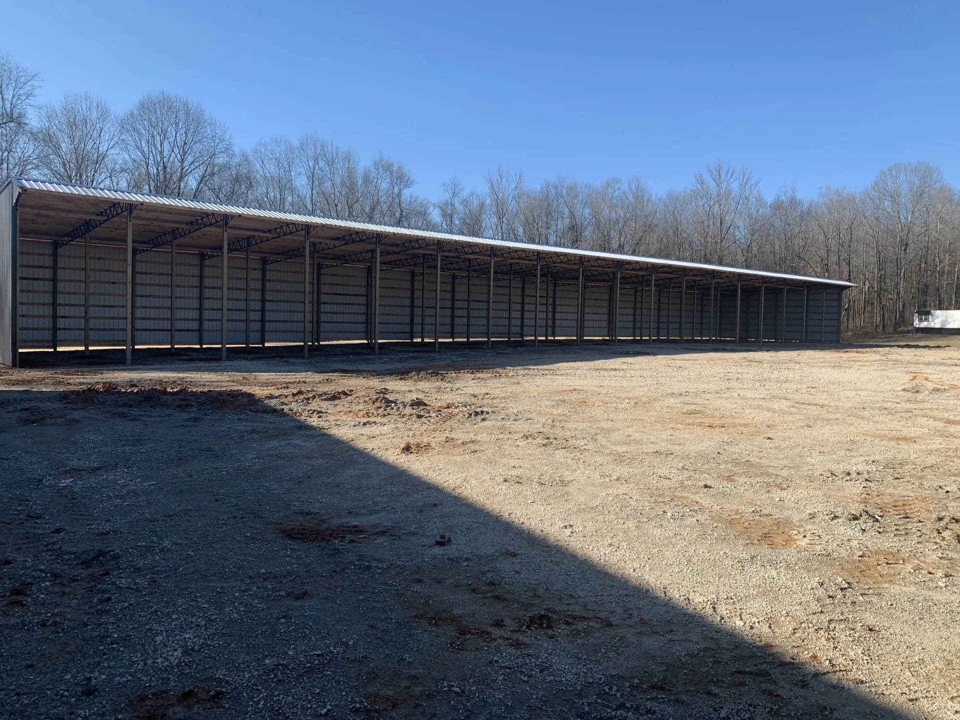 A very long metal agricultural building
