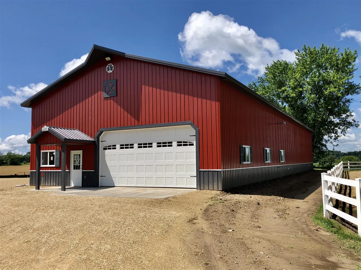 A red metal barn with a white overhead garage door